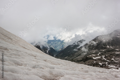 high mountains covered with snow and ice, peaks and valleys in the Caucasus