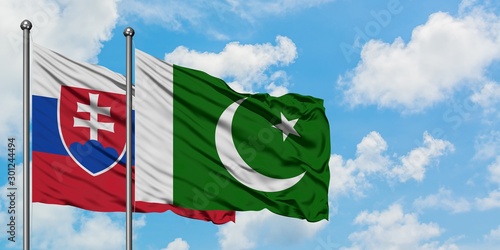 Canvas Print Slovakia and Pakistan flag waving in the wind against white cloudy blue sky together