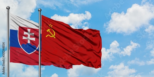 Canvas Print Slovakia and Soviet Union flag waving in the wind against white cloudy blue sky together