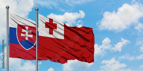 Canvas Print Slovakia and Tonga flag waving in the wind against white cloudy blue sky together