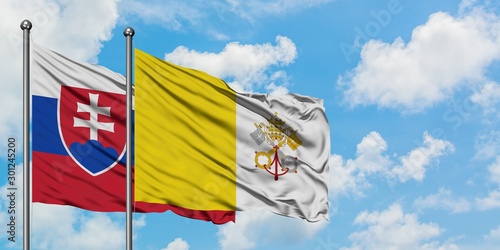 Canvas Print Slovakia and Vatican City flag waving in the wind against white cloudy blue sky together