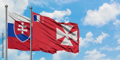 Canvas Print Slovakia and Wallis And Futuna flag waving in the wind against white cloudy blue sky together