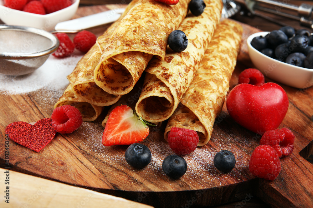 Delicious Tasty Homemade crepes or pancakes with raspberries and mint on rustic background Delicious Tasty Homemade crepes or pancakes with raspberries and mint on rustic background