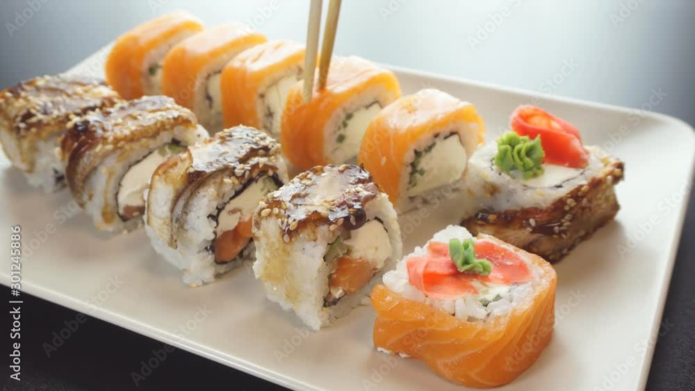 Closeup of chopsticks holding sushi. The view from the top. Closeup of chopsticks holding sushi. The view from the top.