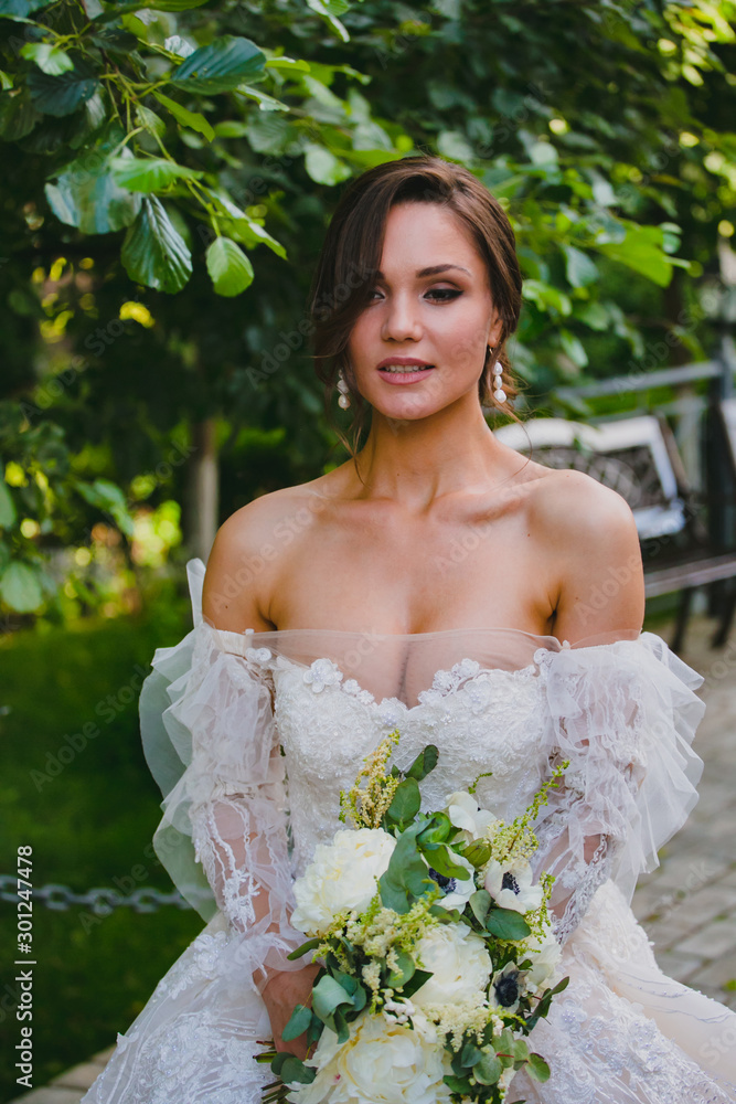Close-up portrait of attractive bride in white dress with naked shoulders Close-up portrait of attractive bride in white dress with naked shoulders