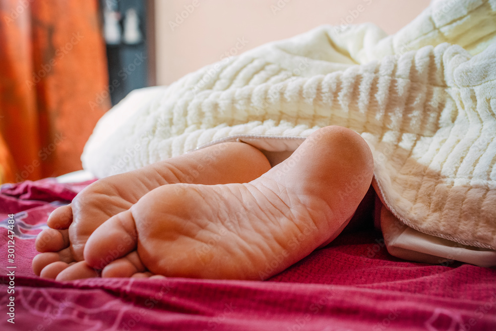 female feet in bed Close up female feet in bed Close up