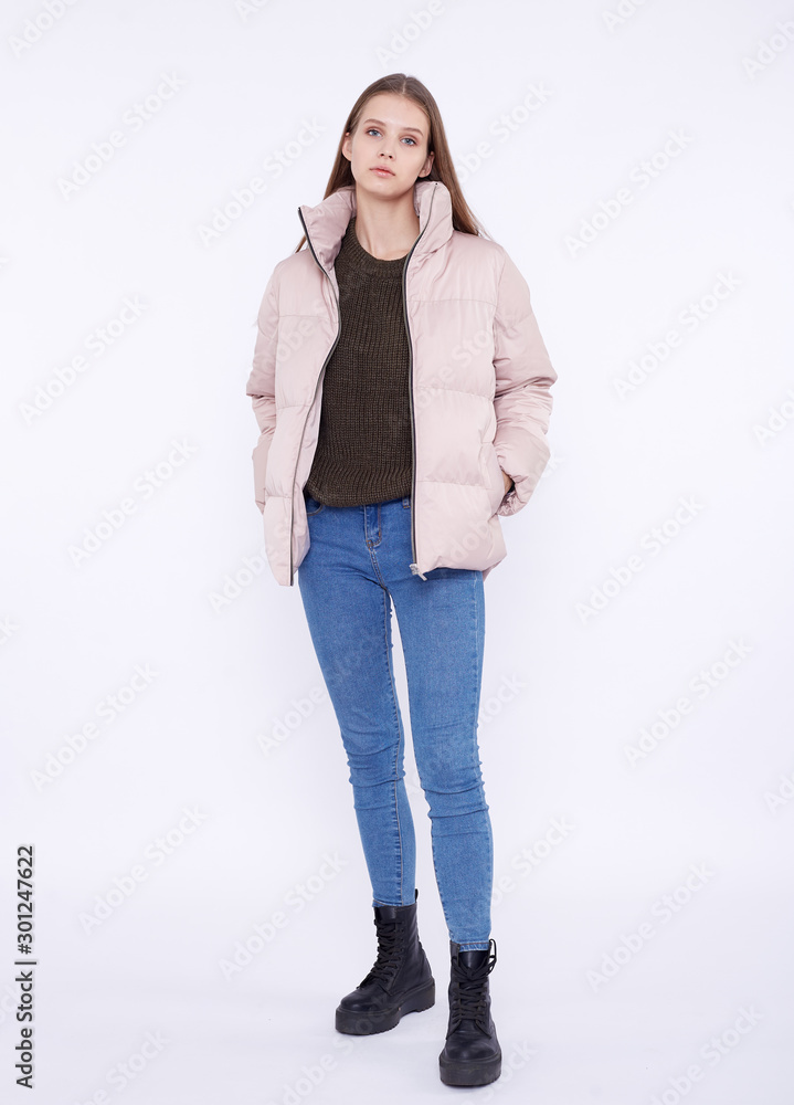 Young girl in a jasmine down jacket isolated on a white background. Young girl in a jasmine down jacket isolated on a white background.