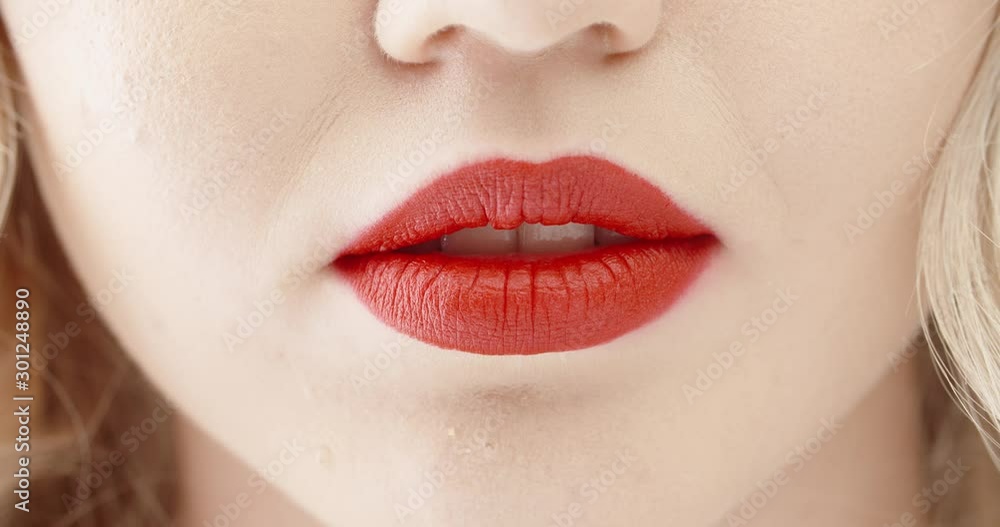 Beautiful girl wearing bright makeup with red lipstick making a positive smile- emotions concept 4k footage close up shot Beautiful girl wearing bright makeup with red lipstick making a positive smile- emotions concept 4k footage close up shot