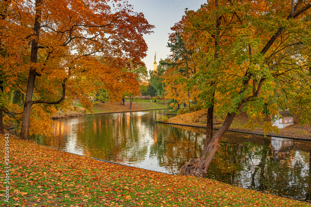 Beautiful autumn colors in the park with river. Riga, Latvia