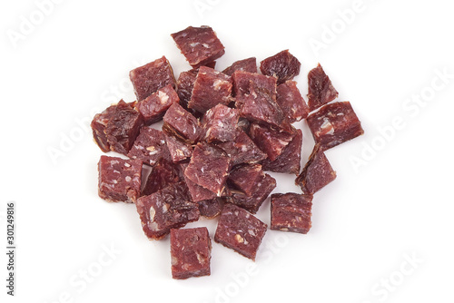 Canvas Print Dry sausage slices, cut by cubes, ingredients, isolated on white background