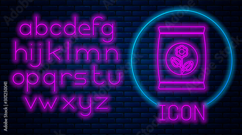 Glowing neon Fertilizer bag icon isolated on brick wall background. Neon light alphabet. Vector Illustration