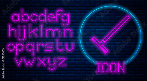 Glowing neon Garden rake icon isolated on brick wall background. Tool for horticulture, agriculture, farming. Ground cultivator. Housekeeping equipment. Neon light alphabet. Vector Illustration