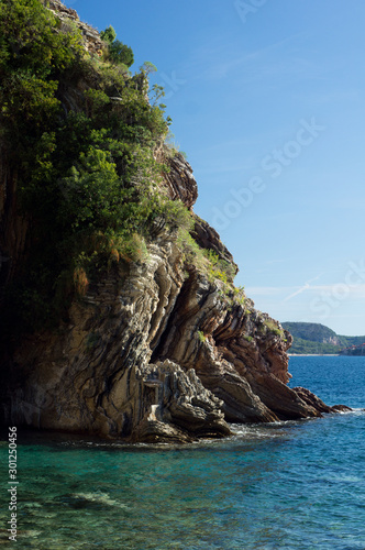 Sea, rocks and Sveti Stefan island from Rafailovici beach