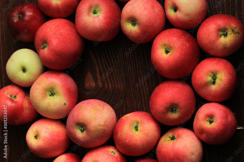 red apples in a basket of willow. red apples on a wooden table red apples in a basket of willow. red apples on a wooden table