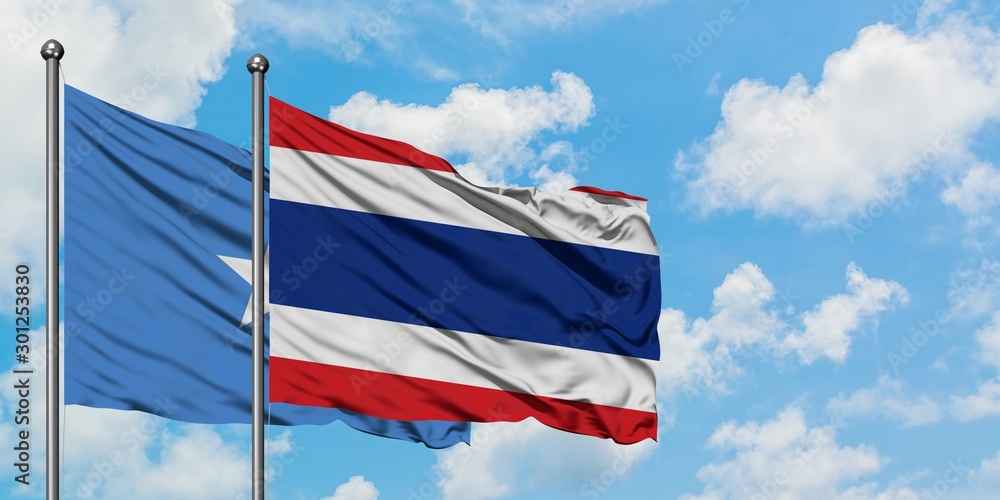 Somalia and Thailand flag waving in the wind against white cloudy blue sky together. Diplomacy concept, international relations.