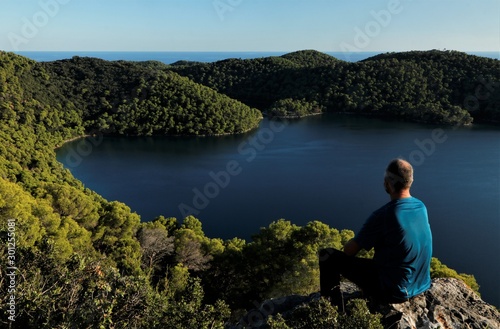 man enjoying the beautiful panoramic view to the fantastic salt lake Veliko Jezero and the Adriatic Sea on Mljet island in Croatia