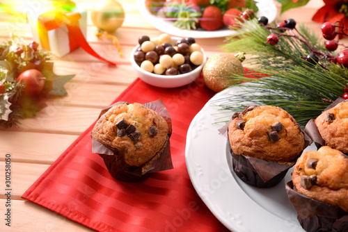 Chocolate chip muffin on christmas wooden table elevated view light
