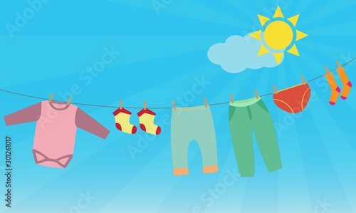 Child washed clothes on the clothesline outdoors on a sunny day