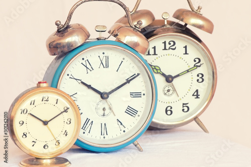 Three vintage alarm clocks of different sizes