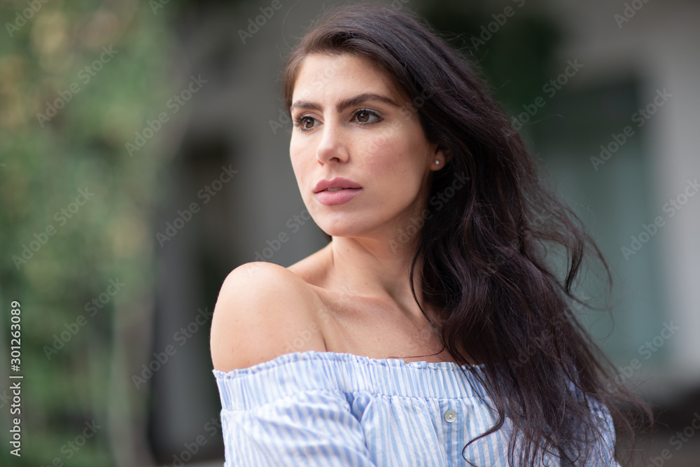 A portrait of a lovely romantic young woman outdoors, inspiringly looking forward A portrait of a lovely romantic young woman outdoors, inspiringly looking forward