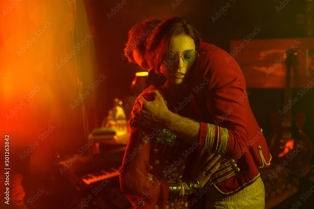 A young man cuddles with an attractive girl. Cinematic style, creative color