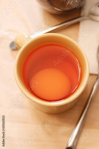 Dyeing an Easter egg in a coffee mug