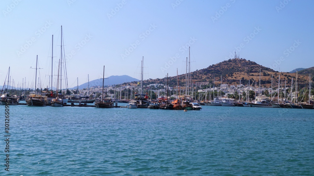  seashore with white yachts in Bodrum in the background mountains and hill