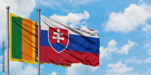 Canvas Print Sri Lanka and Slovakia flag waving in the wind against white cloudy blue sky together