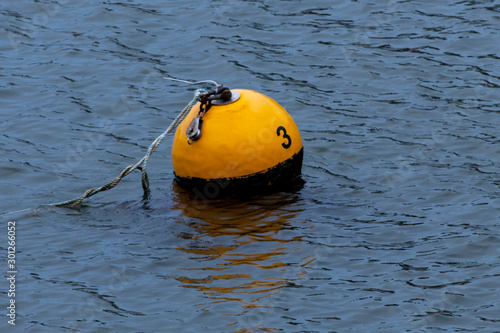 Harbour mooring buoy with the number 3 written on it