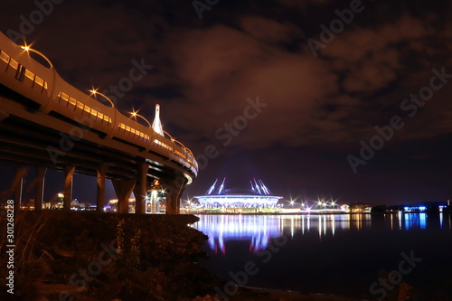 colorful night cityscape with illuminated bridge over river