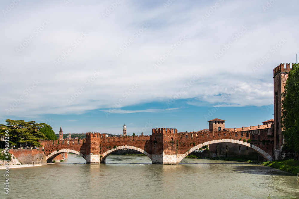 Medieval bridge made of bricks over river in Verona