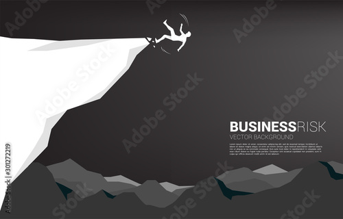 silhouette of businessman slip and falling down from the cliff. Concept for fail and accidental business