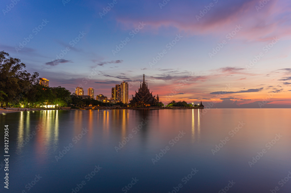 The Sanctuary of Truth (Prasat Mai), Pattaya, Thailand And tall buildings in Pattaya At sunset