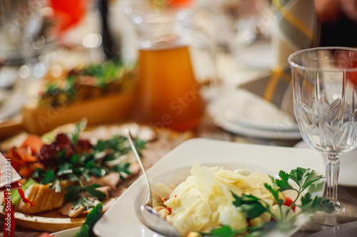 Mashed potatoes with nuts on a plate in a restaurant. Cold appetizers in the restaurant at the banquet in honor of the holiday. New Year's table in Ukraine.