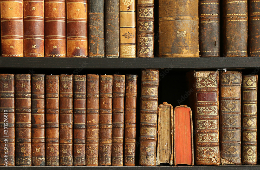 Fototapeta premium old books on wooden shelf