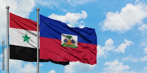 Konstfotografi Syria and Haiti flag waving in the wind against white cloudy blue sky together