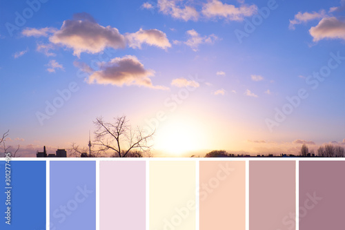 Color matching natural swatch palette from panoramic image of sky over Berlin on sunset with cream and purple fluffy clouds with golden yellow Sun on darkening blue sky