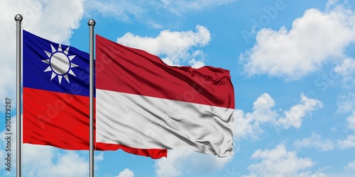 Taiwan and Indonesia flag waving in the wind against white cloudy blue sky together. Diplomacy concept, international relations.