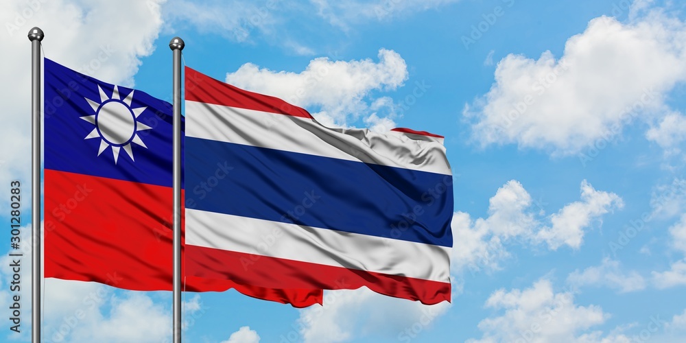 Taiwan and Thailand flag waving in the wind against white cloudy blue sky together. Diplomacy concept, international relations.