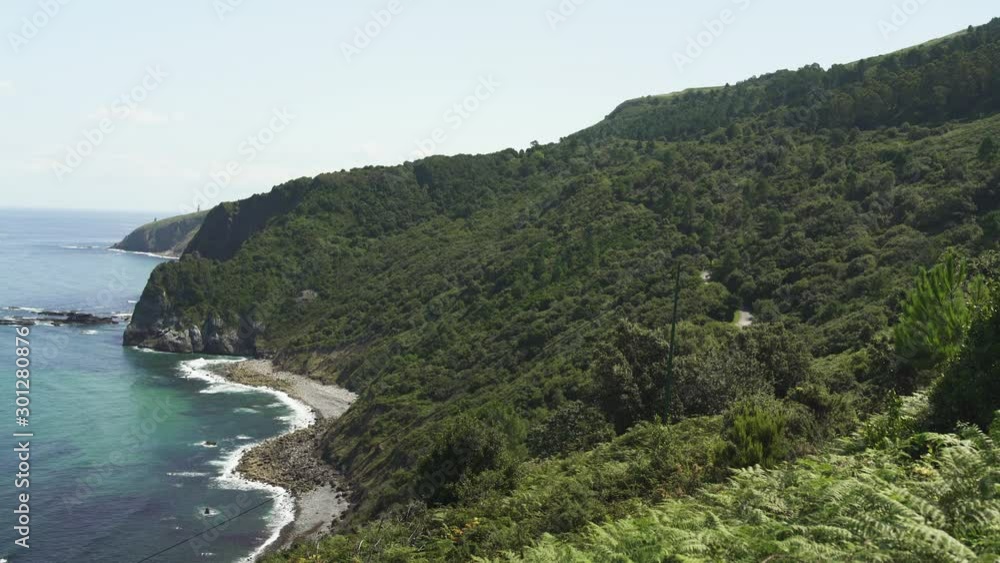 Handy Shot of Gaztelugatxe island in beautiful blue sea with little waves in Spain, during day. Blue sky, bluish color, Clouds, 4K UHD, dense forest with trees. Handy Shot of Gaztelugatxe island in beautiful blue sea with little waves in Spain, during day. Blue sky, bluish color, Clouds, 4K UHD, dense forest with trees.