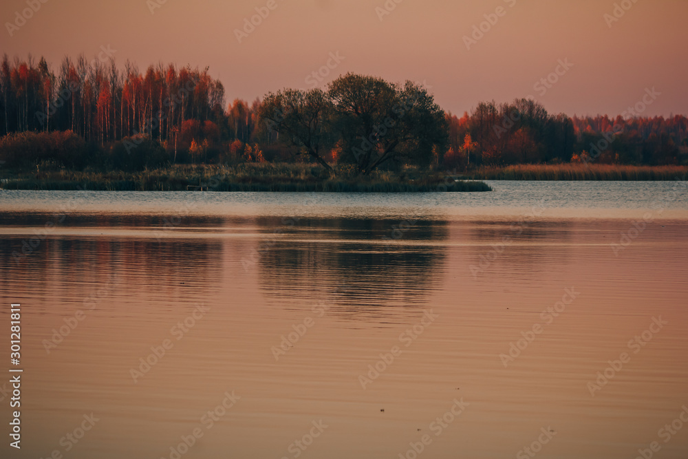 lake and forest in autumn at sunset
