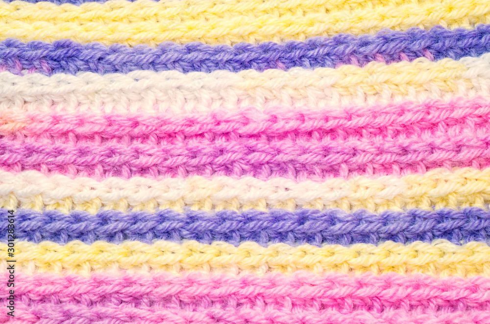Blue, yellow, pink and white stripy knitted scarf texture.
