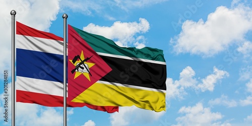 Thailand and Mozambique flag waving in the wind against white cloudy blue sky together. Diplomacy concept, international relations.