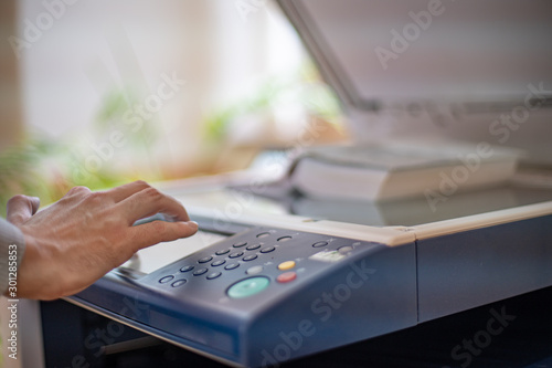 copying a book on a copy machine for study in a library