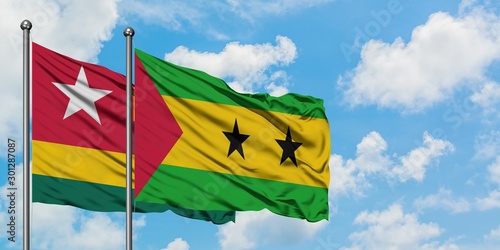 Togo and Sao Tome And Principe flag waving in the wind against white cloudy blue sky together. Diplomacy concept  international relations.