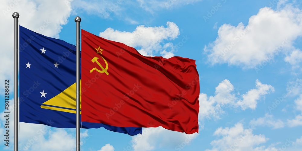 Naklejka premium Tokelau and Soviet Union flag waving in the wind against white cloudy blue sky together. Diplomacy concept, international relations.