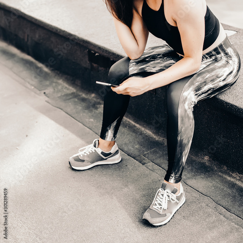 Beautiful sport fitness girl in sportswear doing fitness exercise in the street ,outdoor sports. Urban style.