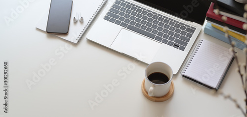 Top view of comfortable workspace with laptop computer and office supplies