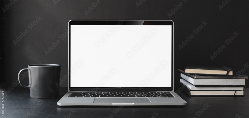 Cropped shot of modern office room with blank screen laptop computer and office supplies Cropped shot of modern office room with blank screen laptop computer and office supplies