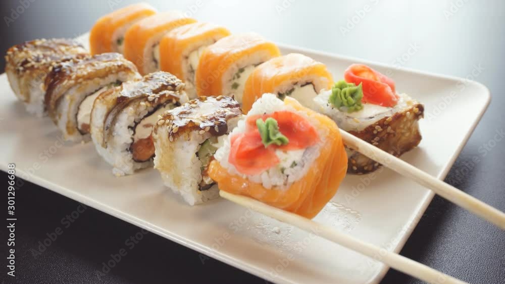 Closeup of chopsticks holding sushi. The view from the top. Closeup of chopsticks holding sushi. The view from the top.